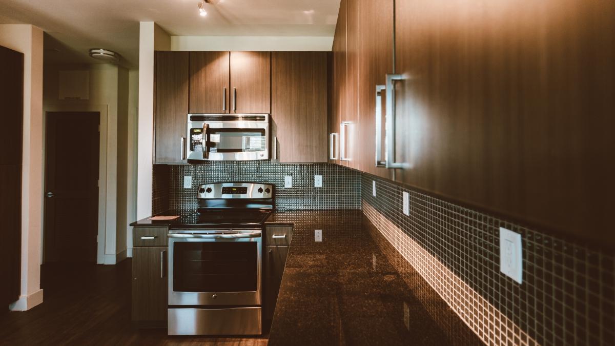 City Vista apartment luxury kitchen with oven, sink, and granite countertops
